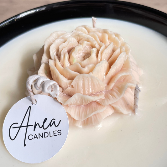 Candle shaped like a rose with 'Anea Candles' label on a white background. PEONY FLOWER SOY NTURAL CANDLE