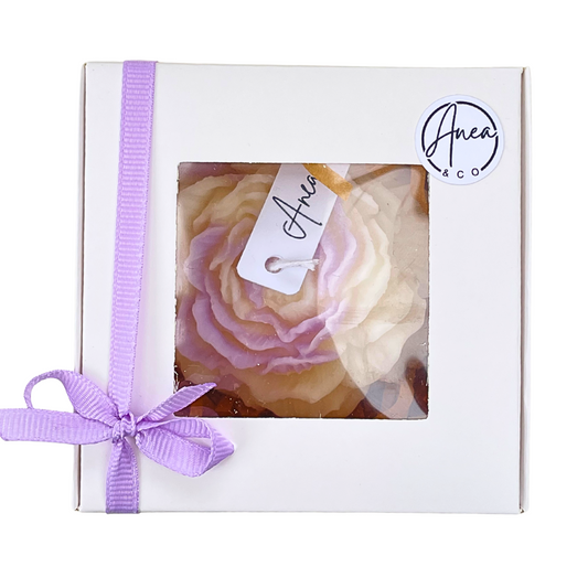 Gift box with a pink rose-shaped soap and a purple ribbon, featuring the brand 'Anea & Co'. PEONY FRESH LINEN CANDLE GIFT BOX 