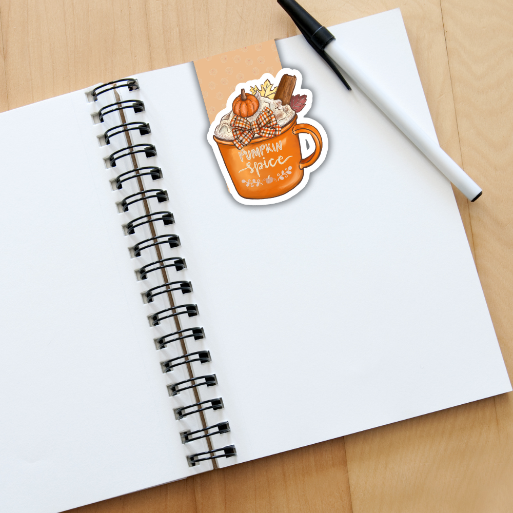 Notebook with a 'Pumpkin Spice' sticker on a wooden surface. Pumpkin and Cinnamon Magnetic Bookmark