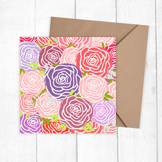 Floral patterned card with a brown envelope on a white wooden surface. Roses Bouquet Birthday Card