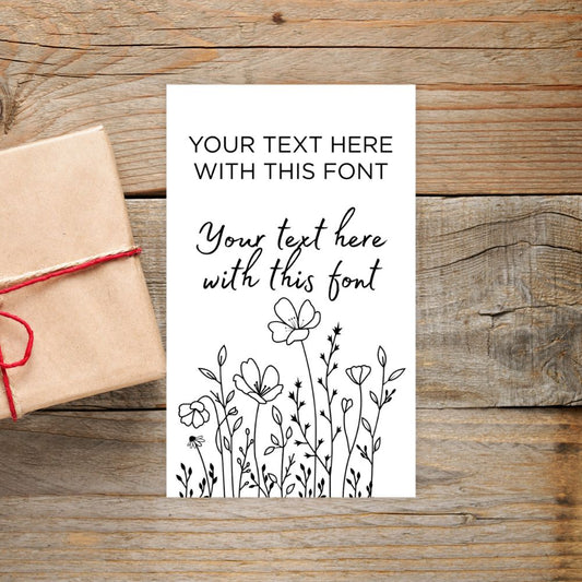 Card with text and floral design on a wooden surface with a gift box.SIMPLE PERSONALISED GIFT TAG