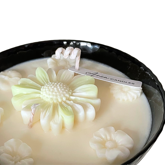 Candle with floral design and 'Avenue Candles' label on a white background. SPRING DAISY SOY CANDLE