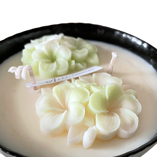 Decorative candles with floral designs on a white background. SPRING FLOWER SOY CANDLE