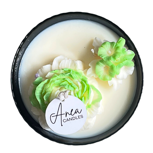 Candle with floral designs and 'Anea Candles' label on a white background. SPRING PEONY SOY CANDLE