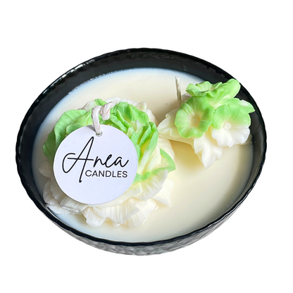 Candle with floral design and 'Anea Candles' label on a white background. SPRING PEONY SOY CANDLE