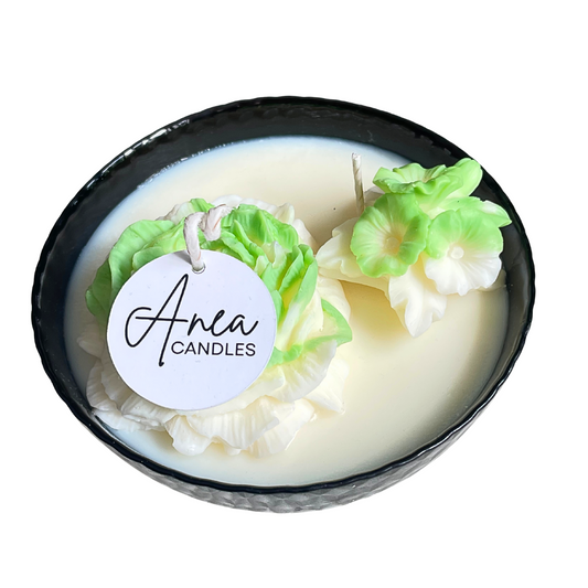 Candle with floral design and 'Anea Candles' label on a white background. SPRING PEONY SOY CANDLE
