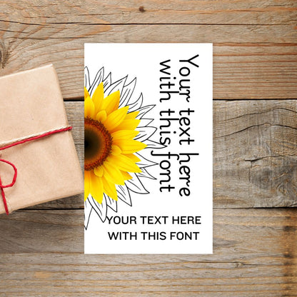 Sunflower design with text placeholder on a wooden surface. SUNFLOWER PERSONALISED GIFT TAG