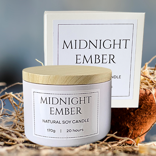 Candle labeled 'Midnight Ember' with a wooden lid on a natural background. Sauvage Inspired soy candle.png