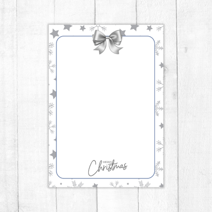 Christmas card with a silver bow and 'Merry Christmas' text on a white background. Silver Christmas Notepad A6 stationery