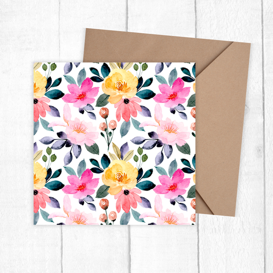 Floral card with a brown envelope on a white wooden surface. Summer Flowers Birthday card