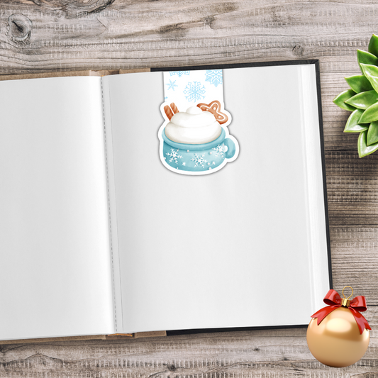 Open notebook with a sticker of a cartoon character in a snowy scene on a wooden surface. Sweet Christmas Magnetic Bookmark