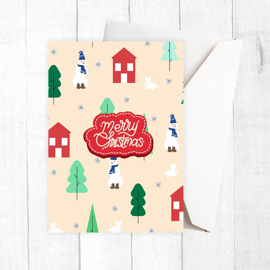 Christmas-themed card with houses, trees, and snowmen on a beige background. VILLAGE CHRISTMAS CARD