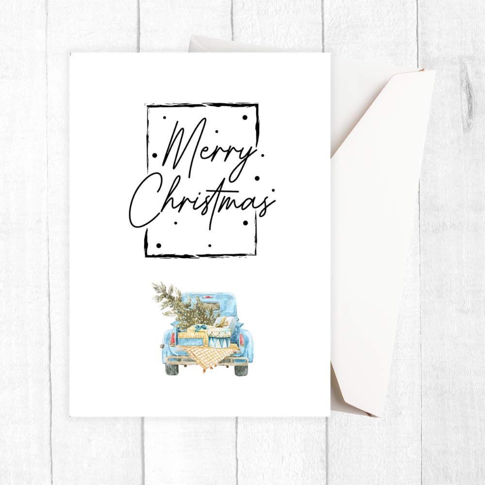 Framed artwork with 'Merry Christmas' text and a blue truck carrying a Christmas tree on a white background.Vintage Car Christmas Card