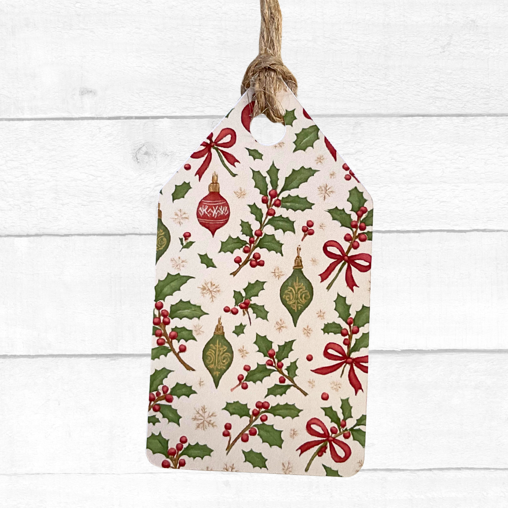 Decorative Christmas tag with holly leaves, berries, and ornaments on a white wooden background. Vintage Christmas Gift Tag Set