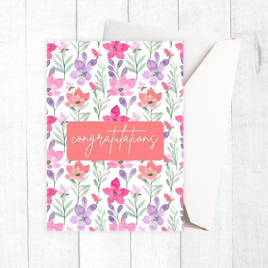 Floral card with 'Congratulations' text on a white wooden surface. Watercolour Flowers Congratulations Card