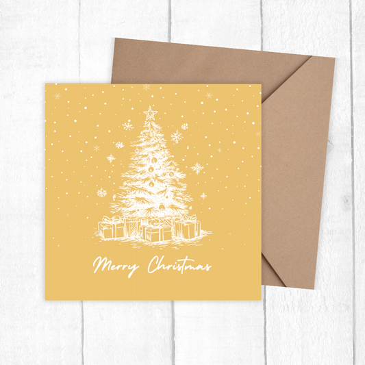 Christmas card with a tree and presents on a yellow background, accompanied by a brown envelope. White Tree Golden Christmas Card