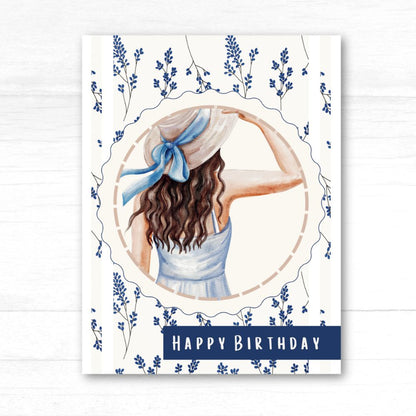 Birthday card with a woman in a hat and dress surrounded by flowers and the text 'Happy Birthday'. Wild Flowers Happy Birthday Card