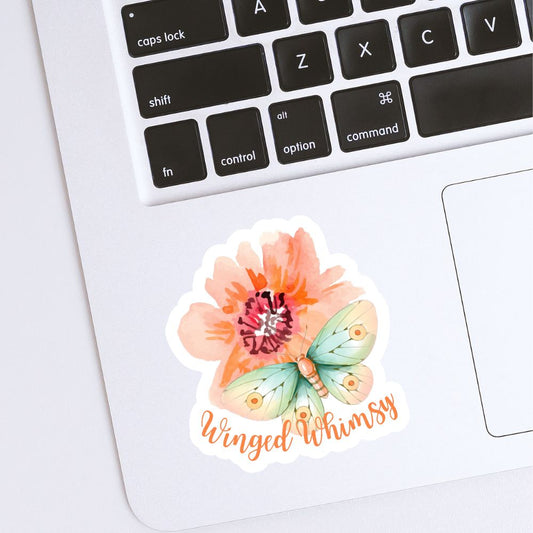 Sticker with a butterfly and flower design on a laptop keyboard. Winged Whimsy Butterfly Sticker