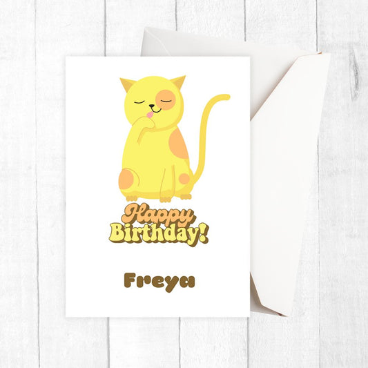 Birthday card with a yellow cat illustration and 'Happy Birthday Freya' text on a white background. Yellow Cat Birthday Personalised Card