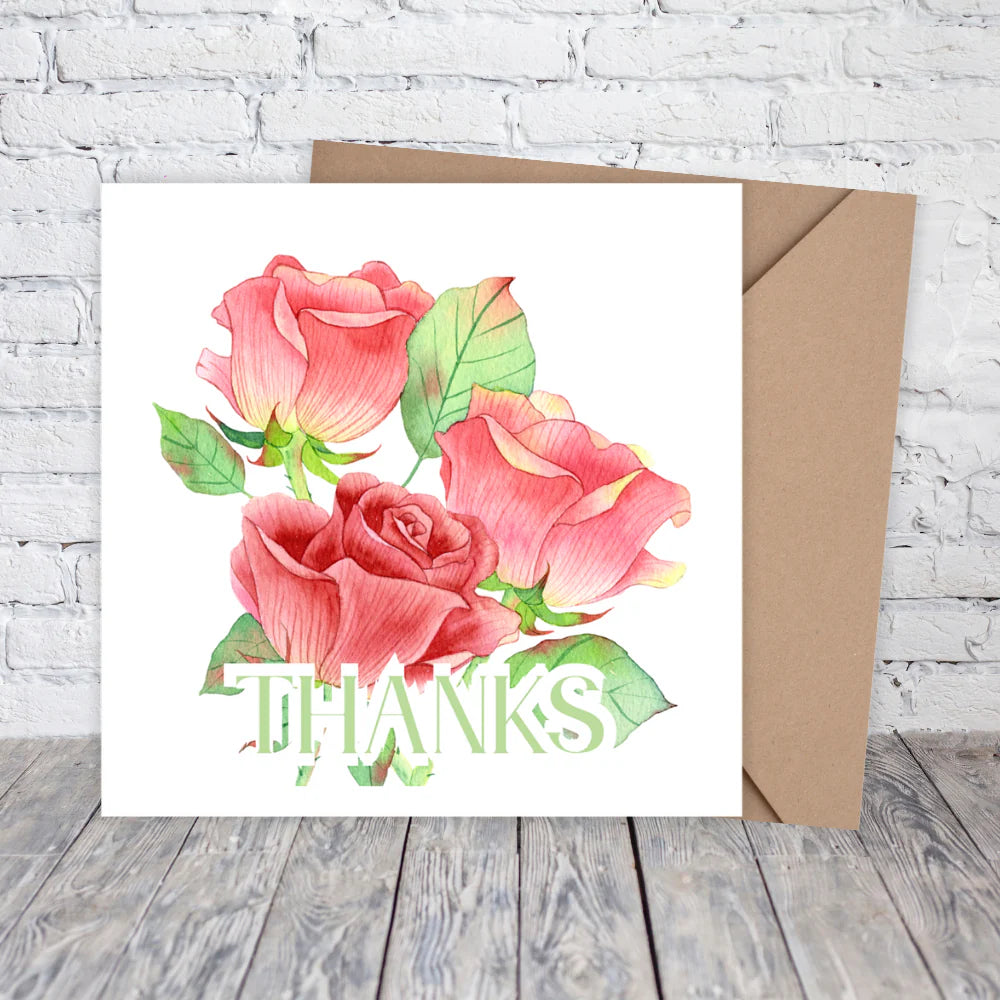 Greeting card with pink roses and 'THANKS' text on a white background with a brown envelope.