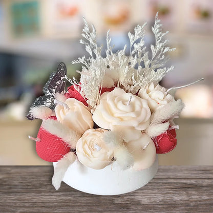 Decorative flower arrangement with white and red flowers on a wooden surface. BUTTERFLY & FLOWER CANDLES CENTREPIECE
