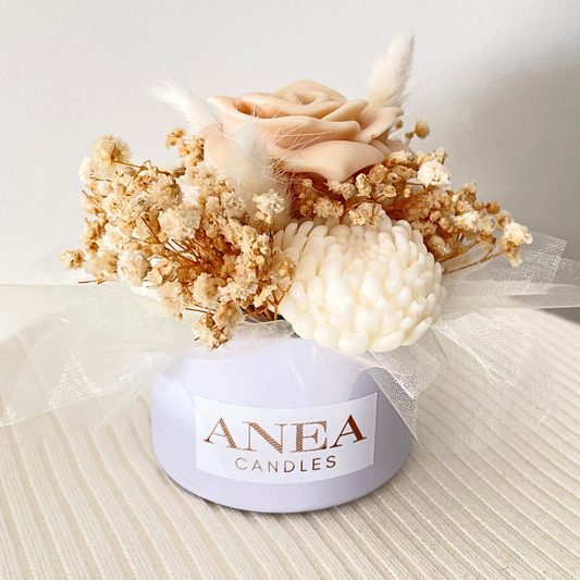 Decorative candle with flowers and 'ANEA CANDLES' label on a neutral background. CREAM WAX MELT FLOWER MINI BOUQUET