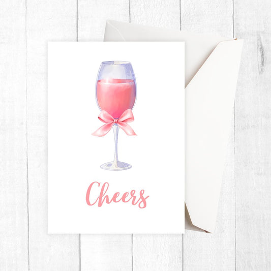 Greeting card with a pink wine glass and 'Cheers' text on a white background. cheers pink cocktail glass birthday card