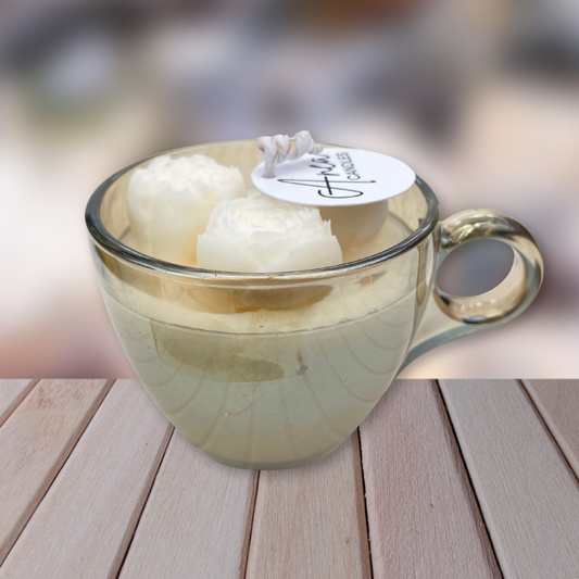 Glass mug with two white固体 on a wooden surface. CHOCOLATE FRESH LINEN CANDLE II