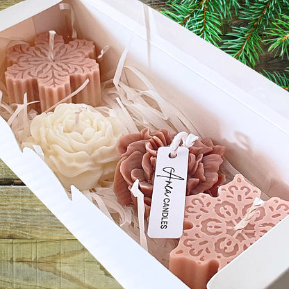Decorative candles in a box with a visible brand tag, set against a natural background. CHRISTMAS SPICE CANDLE GIFT BOX
