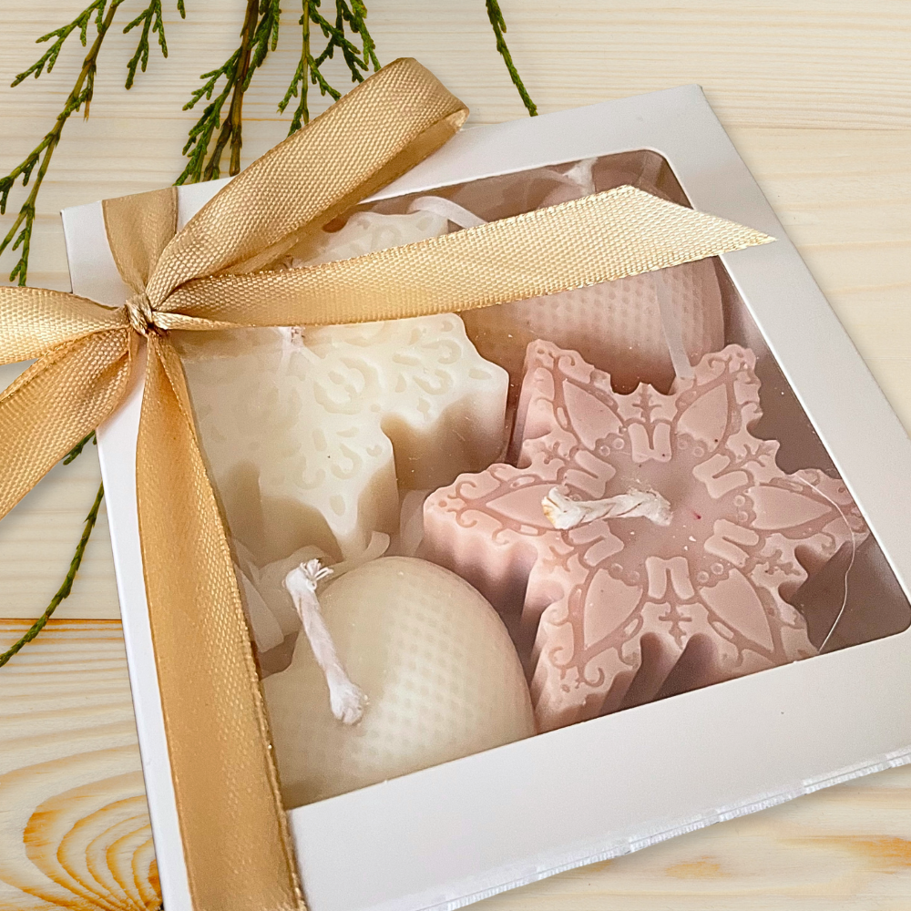 Decorative soap set in a box with a gold ribbon on a wooden surface. CHRISTMAS ORNAMENTS CANDLE GIFT BOX