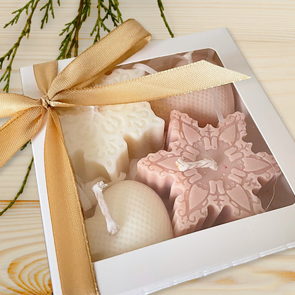 Decorative soap set in a box with a gold ribbon on a wooden surface. CHRISTMAS ORNAMENTS CANDLE GIFT BOX