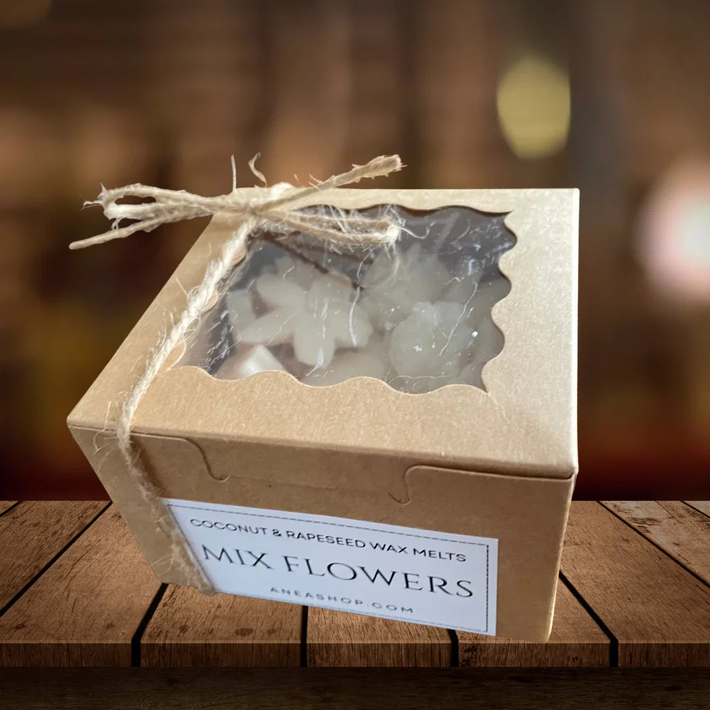 Box of 'Mix Flowers' coconut and rapeseed wax melts on a wooden surface with a blurred background. MIXED FRAGRANCED WAX MELTS BOX