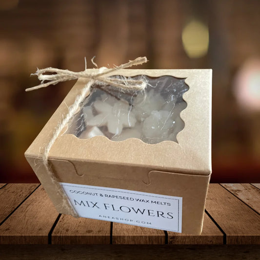 Box of 'Mix Flowers' coconut and rapeseed wax melts on a wooden surface with a blurred background. MIXED FRAGRANCED WAX MELTS BOX
