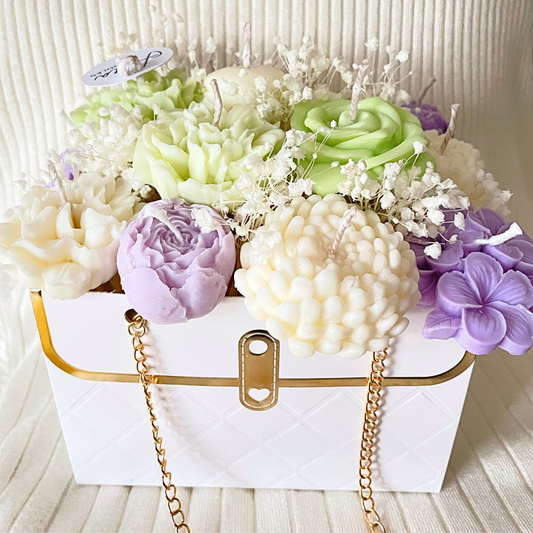 Decorative arrangement of flowers in a white box with gold chain on a light background. LILAC & GREEN CANDLE FLOWER BOUQUET BAG