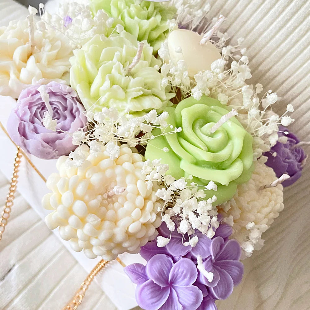 Pastel-colored flower-shaped candles on a white surface. LILAC & GREEN CANDLE FLOWER BOUQUET BAG