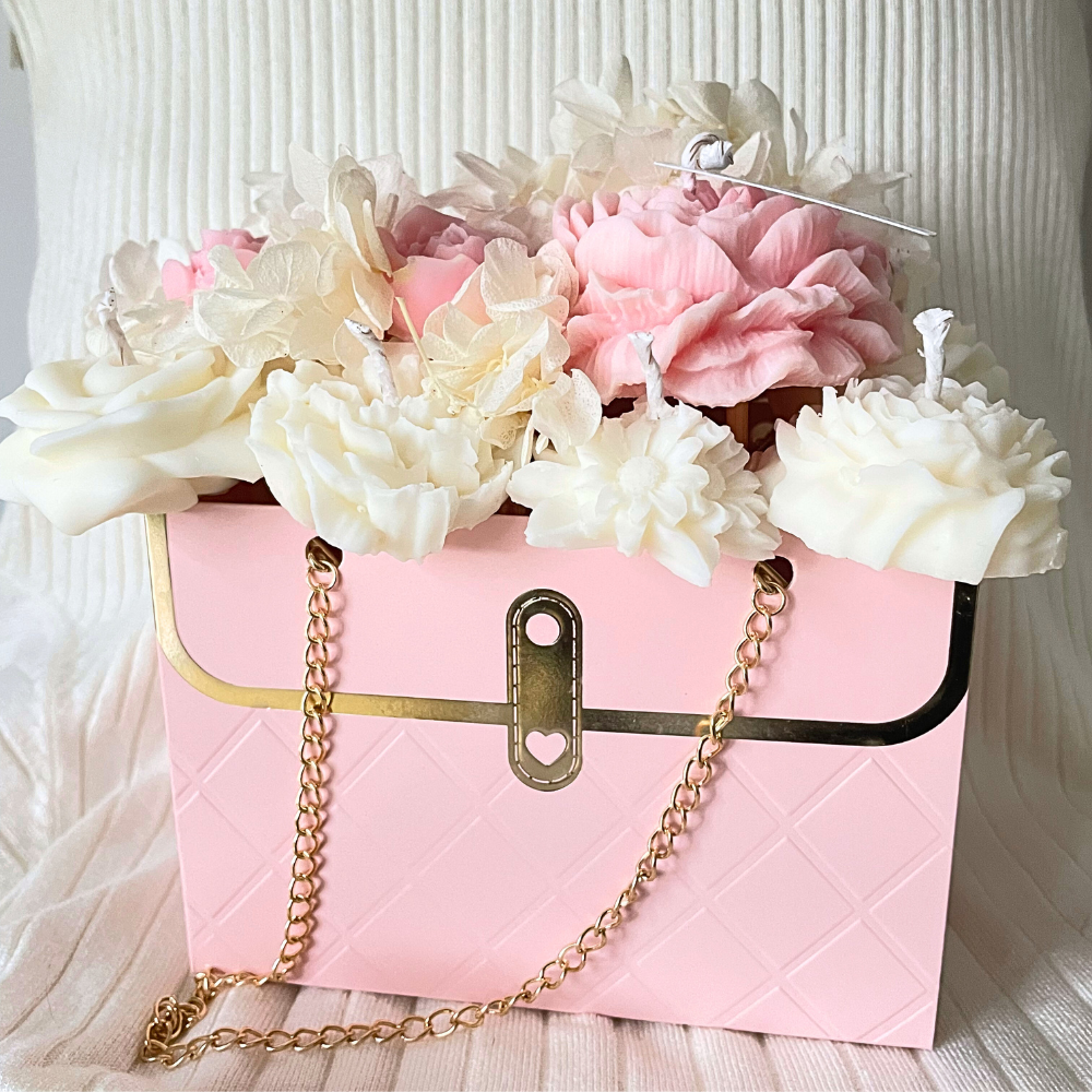 Pink handbag with gold chain and flowers on a textured white background. PINK CANDLE FLOWER BOUQUET BAG