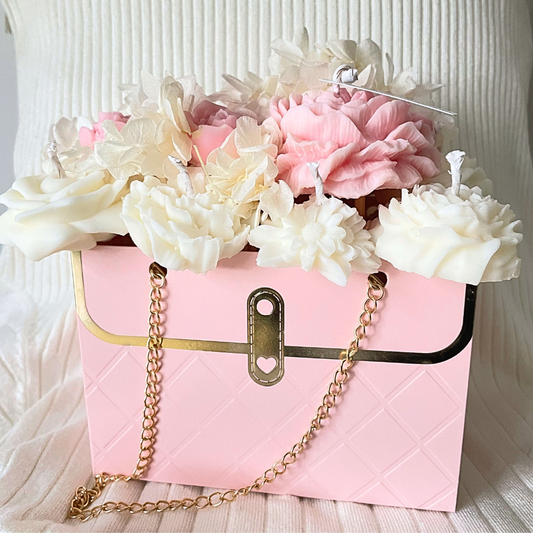 Pink handbag with gold chain and flowers on a textured white background. PINK CANDLE FLOWER BOUQUET BAG