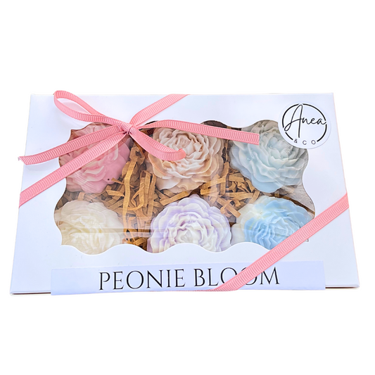 Gift box of peony-shaped bath bombs with a pink ribbon on a white background. flowers WAX MELTS GIFT BOX
