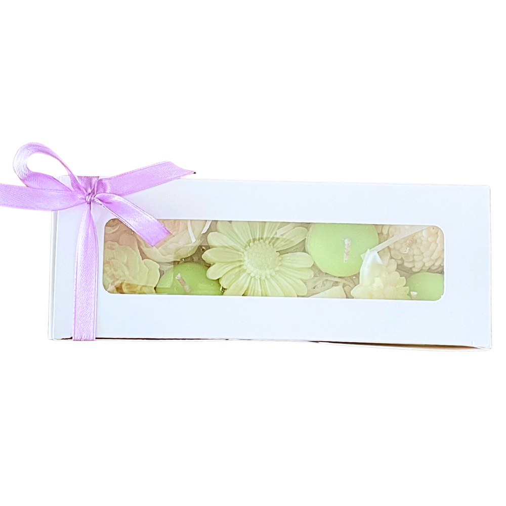 Packaged candles with floral design and pink ribbon on a white background. flower soy wax and candle