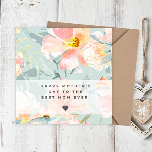 Floral Mother's Day card with a heart-shaped tag on a wooden surface. PASTEL FLOWERS MOTHER'S DAY CARD 