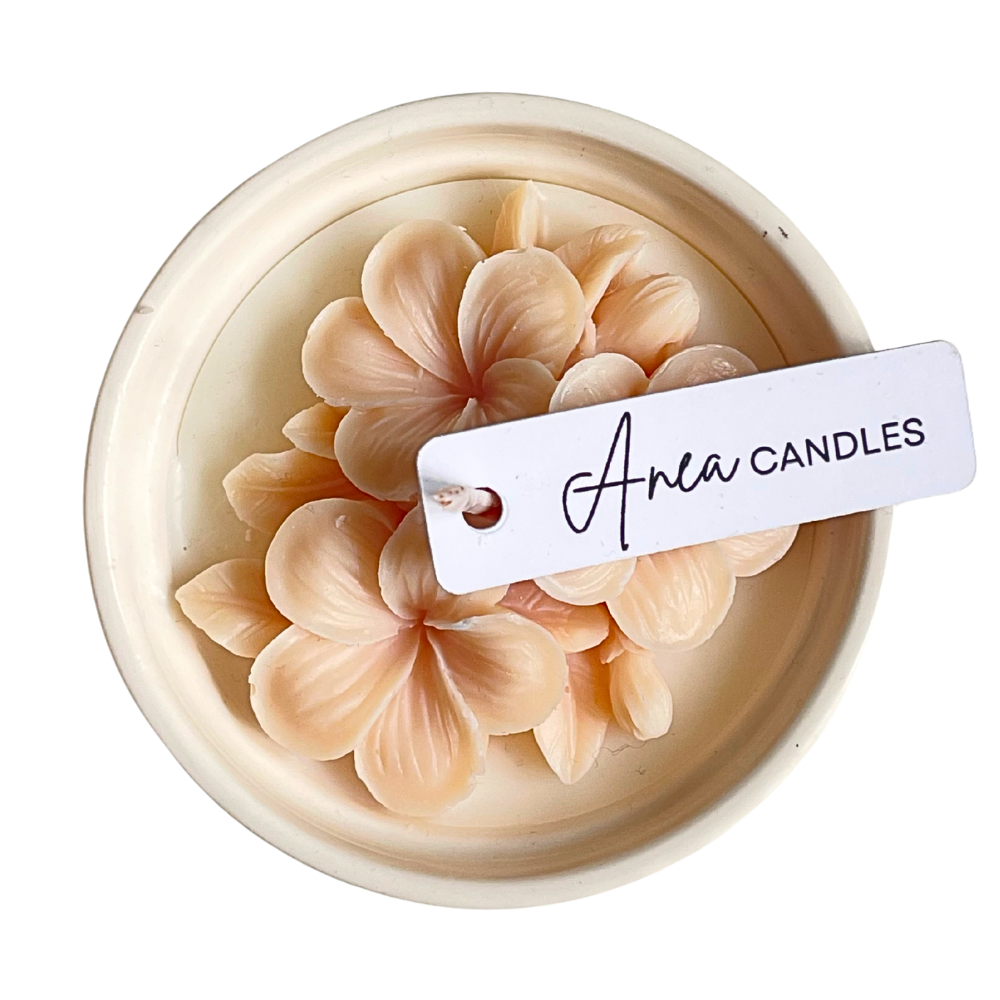 Decorative candle with floral design and 'Aria Candles' tag on a white background. natural flower SOY CANDLE