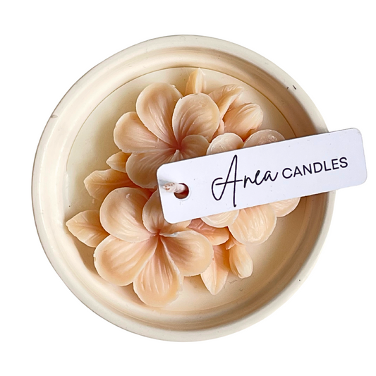 Decorative candle with floral design and 'Aria Candles' tag on a white background. natural flower SOY CANDLE