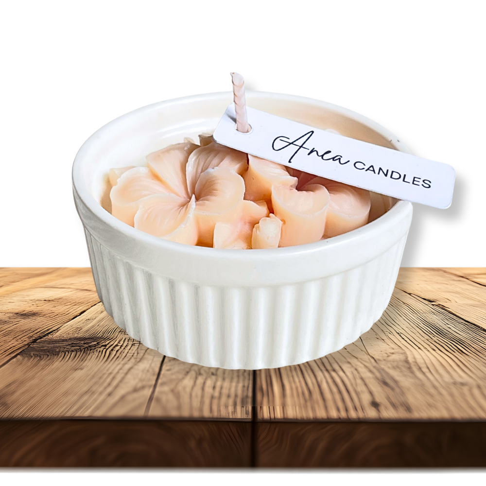 White bowl with pink candles on a wooden surface, featuring 'Anew Candles' tag. natural flower SOY CANDLE