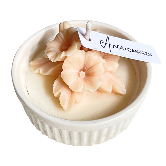 Candle with floral design in a white container, featuring 'Anea Candles' label. natural flower SOY CANDLE