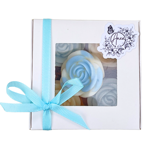 Gift box with blue ribbon and floral label on a white background. roses WAX MELTS GIFT BOX