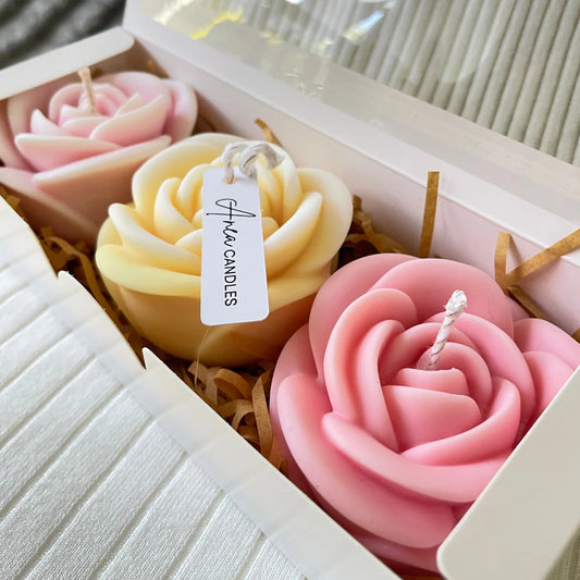 Rose-shaped candles in a box with a visible brand tag, set against a neutral background.LARGE ROSES CANDLE GIFT BOX