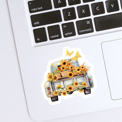 Sticker of a truck with sunflowers on a laptop keyboard. vintage car with sunflowers sticker